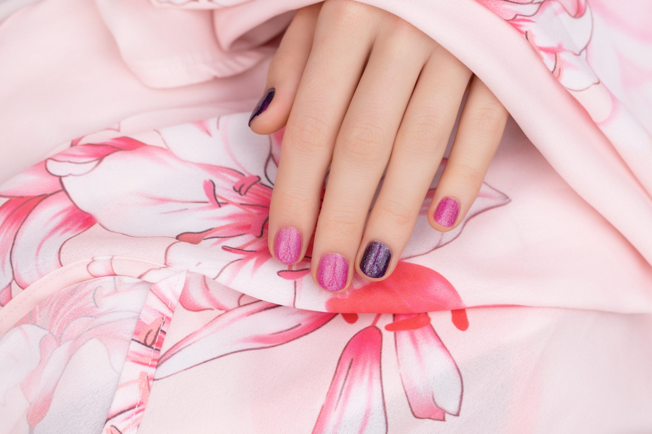 Pink nail design. Female hand with glitter manicure