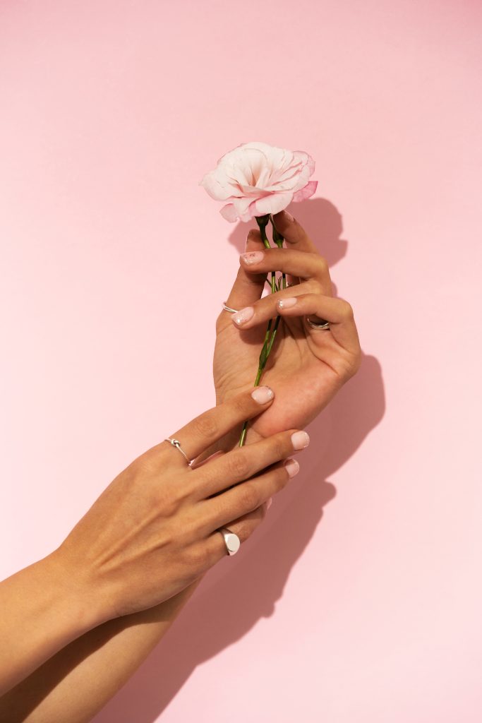 Woman Showing Her Nail Art Fingernails With Flower 683x1024